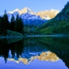 The Maroon Bells are reflected off a mountain lake